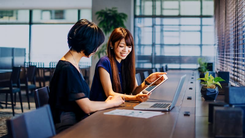 Blog - The Need for Mandarin in Hong Kong Financial Services - Two Female Colleagues In A Meeting